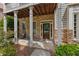 Close-up of the front porch with stone columns and a cozy seating area, showcasing the home's entrance at 944 Hidden Falls Se Ln, Smyrna, GA 30082