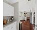 Bright kitchen with white cabinetry, stainless steel appliances, and open layout to the living room at 944 Hidden Falls Se Ln, Smyrna, GA 30082