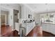 Well-lit kitchen with white cabinets, granite countertops, open floor plan, and stainless appliances at 944 Hidden Falls Se Ln, Smyrna, GA 30082