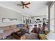 Open-concept living room flowing into the kitchen features hardwood floors and a ceiling fan at 944 Hidden Falls Se Ln, Smyrna, GA 30082
