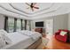 Bright main bedroom with three large windows, a ceiling fan, and access to a full ensuite bathroom at 944 Hidden Falls Se Ln, Smyrna, GA 30082