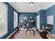 Home office featuring hardwood floors, blue walls, bright windows, and a modern work setup at 944 Hidden Falls Se Ln, Smyrna, GA 30082