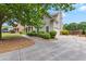 Side exterior view of home, showcasing the attached garage and driveway with manicured landscaping at 944 Hidden Falls Se Ln, Smyrna, GA 30082