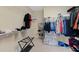 Organized walk-in closet with wire shelving and several drawers for clothing storage at 944 Hidden Falls Se Ln, Smyrna, GA 30082