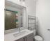 Bathroom with large mirror, stylish vanity, shelving, and shower with curtain at 1225 Chelsea Nw Cir, Atlanta, GA 30318