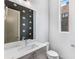 Modern half bathroom features a black accent wall, stylish vanity, and a decorative gold polka dot design at 1225 Chelsea Nw Cir, Atlanta, GA 30318