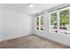 Bright bedroom with three large windows, neutral carpet, and white walls at 1225 Chelsea Nw Cir, Atlanta, GA 30318