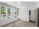 Bright bedroom with three large windows, neutral carpet, and white walls at 1225 Chelsea Nw Cir, Atlanta, GA 30318