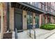 Modern townhome entrance featuring a brick facade, a steel awning, and a poured concrete pathway at 1225 Chelsea Nw Cir, Atlanta, GA 30318