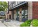 Modern townhome entrance featuring a brick facade, a steel awning, and professionally landscaped bushes at 1225 Chelsea Nw Cir, Atlanta, GA 30318