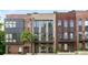 Modern townhomes featuring brick exteriors, black trim, balconies and professionally landscaped front yards at 1225 Chelsea Nw Cir, Atlanta, GA 30318
