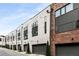 Modern townhomes feature a blend of sleek white stucco and classic brick for sophisticated street appeal at 1225 Chelsea Nw Cir, Atlanta, GA 30318