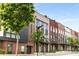 Modern townhomes featuring brick exteriors, black trim, balconies and professionally landscaped front yards at 1225 Chelsea Nw Cir, Atlanta, GA 30318