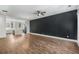 Open concept with a black accent wall and hardwood flooring leading into kitchen at 1225 Chelsea Nw Cir, Atlanta, GA 30318