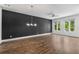 Open living room with hardwood floors, modern lighting and large windows providing ample light at 1225 Chelsea Nw Cir, Atlanta, GA 30318