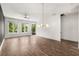 Bright living room features hardwood floors, large windows, and a modern light fixture at 1225 Chelsea Nw Cir, Atlanta, GA 30318