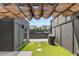 A modern rooftop patio with a grill, turf, and pergola offering a cozy outdoor space with city views at 1225 Chelsea Nw Cir, Atlanta, GA 30318