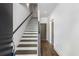 Bright foyer with modern staircase featuring wood treads, white risers, and white walls at 1225 Chelsea Nw Cir, Atlanta, GA 30318