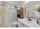 Bathroom featuring a shower-tub combo, sleek vanity, and modern fixtures at 1858 Perry Nw Blvd, Atlanta, GA 30318