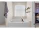 Relaxing soaking tub with a shower and decorative wall shelves in a calming bathroom at 1858 Perry Nw Blvd, Atlanta, GA 30318