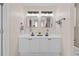 Bathroom with double sinks, sleek black fixtures, and white cabinetry at 1858 Perry Nw Blvd, Atlanta, GA 30318