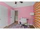 Bright bedroom with colorful accent wall, desk, and ceiling fan at 1858 Perry Nw Blvd, Atlanta, GA 30318