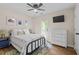 Cozy bedroom with TV, ceiling fan, and natural light, creating a welcoming atmosphere at 1858 Perry Nw Blvd, Atlanta, GA 30318