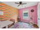 Vibrant bedroom with colorful accent wall, desk, and natural light at 1858 Perry Nw Blvd, Atlanta, GA 30318