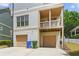 Rear exterior view of the home showing the two car garage and balcony at 1858 Perry Nw Blvd, Atlanta, GA 30318
