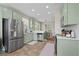 Charming kitchen features light green cabinetry and stainless-steel appliances, great for cooking at 1858 Perry Nw Blvd, Atlanta, GA 30318