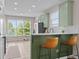 Stylish kitchen with light green cabinets, modern appliances, and bar seating at 1858 Perry Nw Blvd, Atlanta, GA 30318