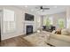 Bright living room with fireplace, large windows, ceiling fan, and modern decor with hardwood floors at 1858 Perry Nw Blvd, Atlanta, GA 30318