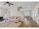 Open-concept living room with hardwood floors, neutral decor, a staircase, and plenty of natural light at 1858 Perry Nw Blvd, Atlanta, GA 30318