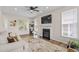 Sunlit living room with fireplace, large windows, ceiling fan, modern decor and plush neutral rug at 1858 Perry Nw Blvd, Atlanta, GA 30318