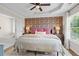 Serene main bedroom with a tray ceiling, wallpaper accent wall, and abundant natural light at 1858 Perry Nw Blvd, Atlanta, GA 30318