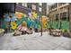 Enjoy the charming outdoor patio with its decorative mural, fire pit, and comfortable seating area at 1858 Perry Nw Blvd, Atlanta, GA 30318