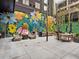 An outdoor patio with a mural, lounge seating, and dining tables, perfect for relaxation at 1858 Perry Nw Blvd, Atlanta, GA 30318