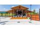 Community pool with covered seating area, lounge chairs and landscaped surroundings at 1858 Perry Nw Blvd, Atlanta, GA 30318