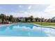 Community pool surrounded by manicured lawn and neighborhood homes under a bright, cloudy sky at 1858 Perry Nw Blvd, Atlanta, GA 30318