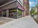 A corner view of a brick and steel restaurant featuring large windows and a visible pick-up window at 1858 Perry Nw Blvd, Atlanta, GA 30318