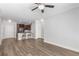 Open concept living space with a kitchen island with barstool seating, dark cabinets, and hardwood floors at 901 Abernathy Ne Rd # 2050, Sandy Springs, GA 30328