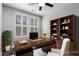 Home office with built-in shelving, a large desk, and natural light at 901 Abernathy Ne Rd # 2050, Sandy Springs, GA 30328