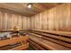 Relaxing wooden sauna room with tiered benches and a traditional stone heater for ultimate relaxation at 901 Abernathy Ne Rd # 2050, Sandy Springs, GA 30328