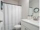 Clean bathroom with white vanity, framed mirror, fresh towels, and a classic shower curtain at 1815 La Dawn Nw Ln, Atlanta, GA 30318