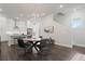 An open-concept dining area with modern chandelier connecting the kitchen and living spaces at 1815 La Dawn Nw Ln, Atlanta, GA 30318