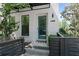 Inviting front entrance with a teal door, white brick, modern address numbers, and a stylish metal awning at 1815 La Dawn Nw Ln, Atlanta, GA 30318