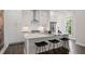 Well-lit kitchen with white cabinetry, a waterfall island, stainless steel appliances, and bar stool seating at 1815 La Dawn Nw Ln, Atlanta, GA 30318