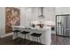 Modern kitchen showcasing white cabinets, stainless steel appliances, and a waterfall island with seating at 1815 La Dawn Nw Ln, Atlanta, GA 30318