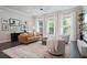 Bright living room features large windows, modern furniture, and a stylish rug at 1815 La Dawn Nw Ln, Atlanta, GA 30318