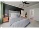 Main bedroom with a gray, tufted headboard and access to the bathroom and walk-in closet at 1815 La Dawn Nw Ln, Atlanta, GA 30318